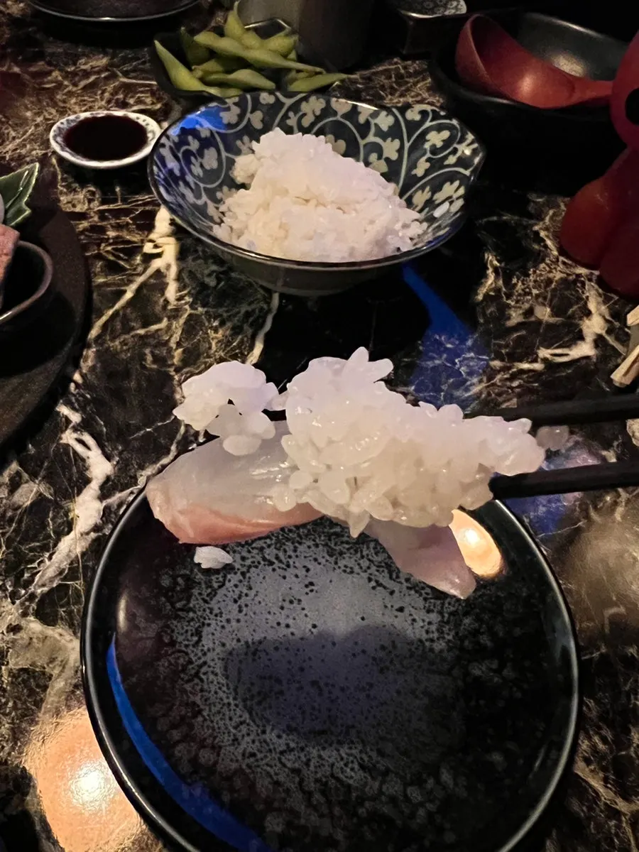 A bowl of rice served alongside the sashimi