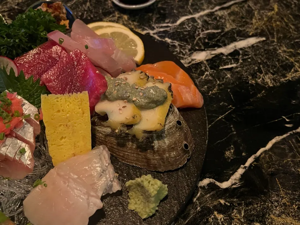 A piece of smooth, glossy white-fish sashimi