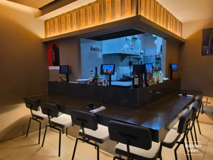 Interior of Izakaya Kitsune with bar seating