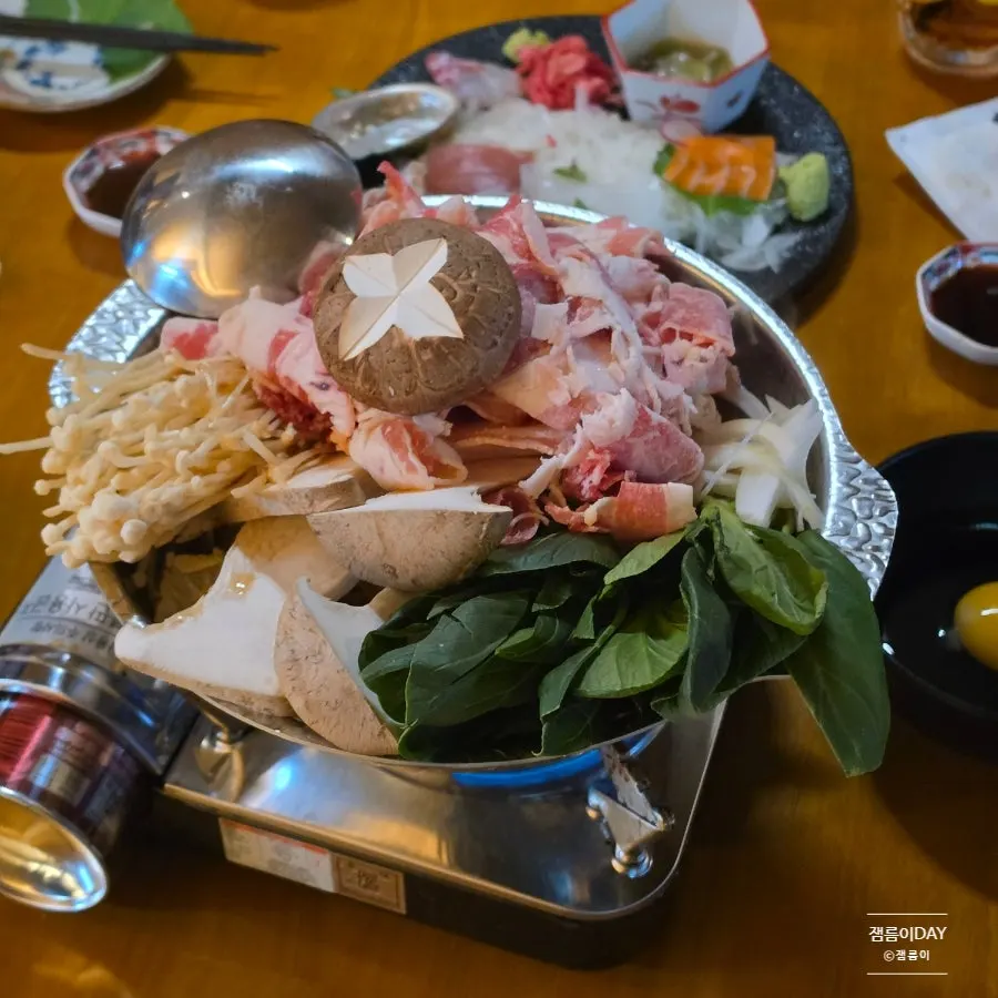 Picking up a piece of sashimi with chopsticks