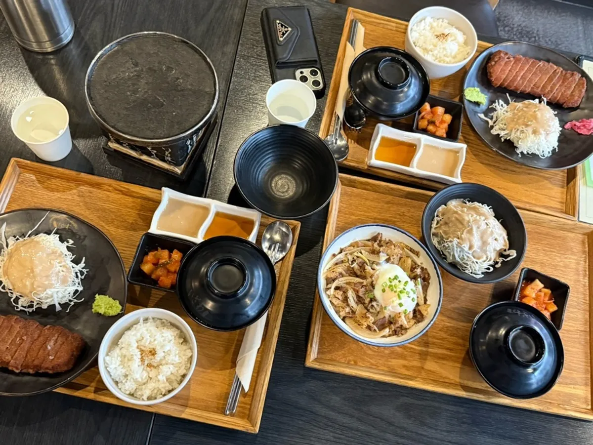 Table set for three with two gyukatsu and one gyudon