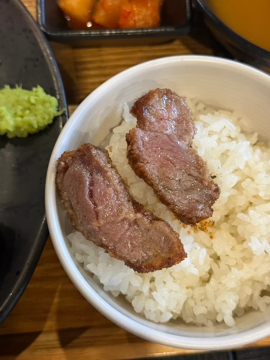Pieces of gyukatsu cooking on the grill