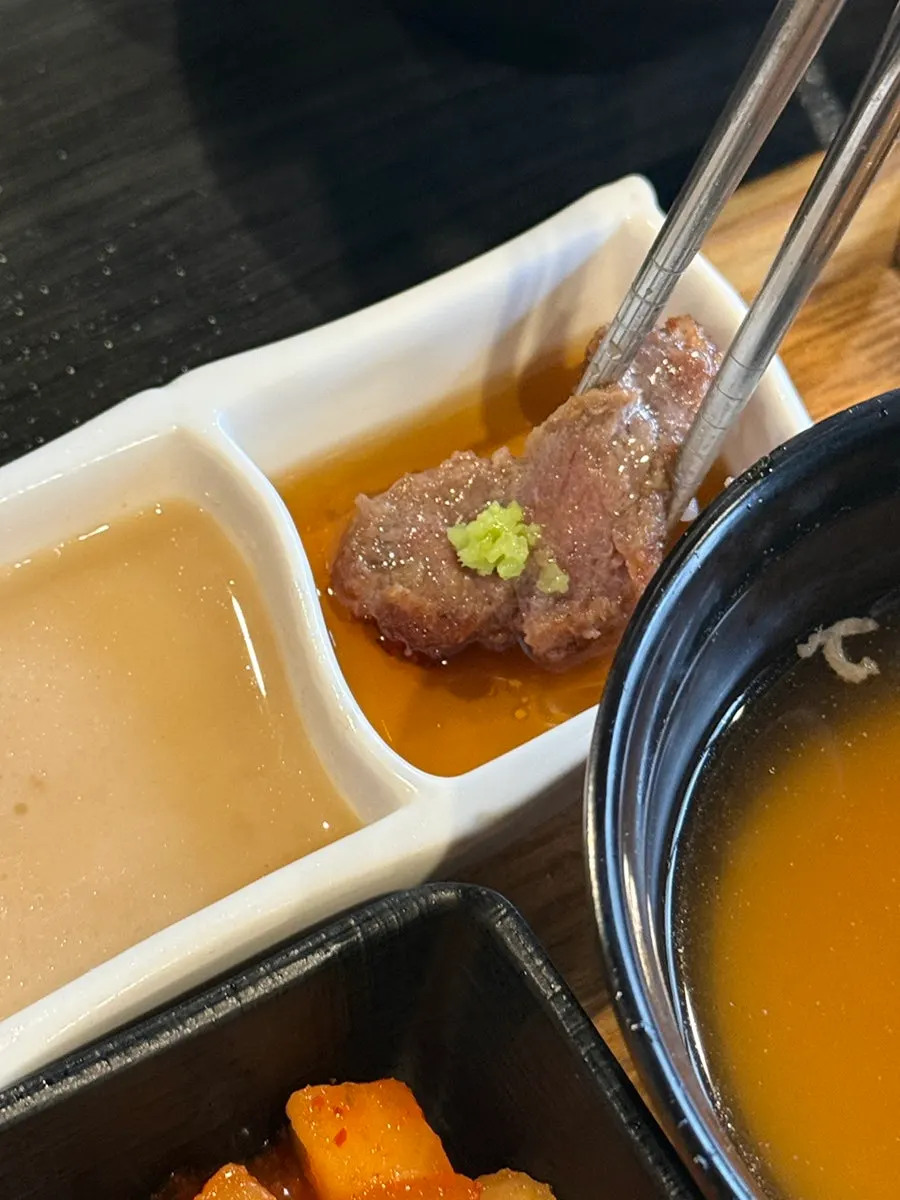 Grilled gyukatsu placed on top of a rice bowl