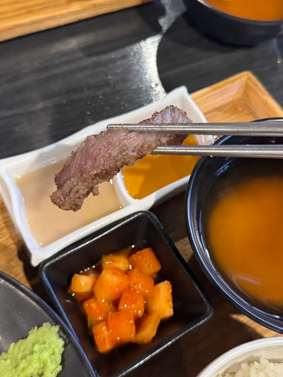 A piece of gyukatsu served with wasabi