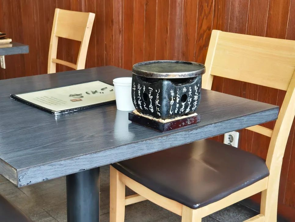 Table set with menu, paper cups, and a mini brazier