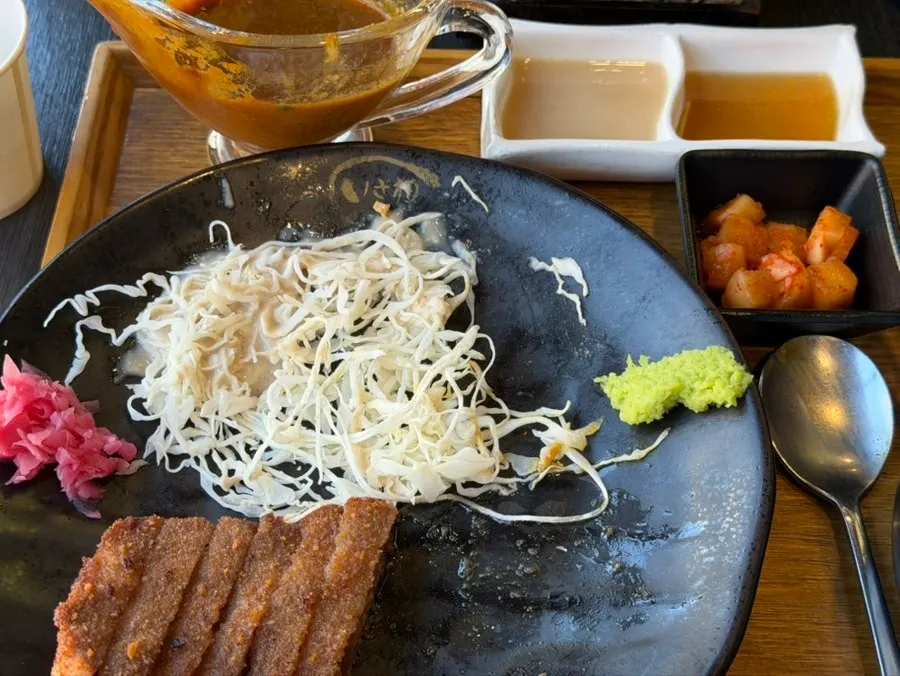 Cross-section of gyukatsu dipped in wasabi soy sauce