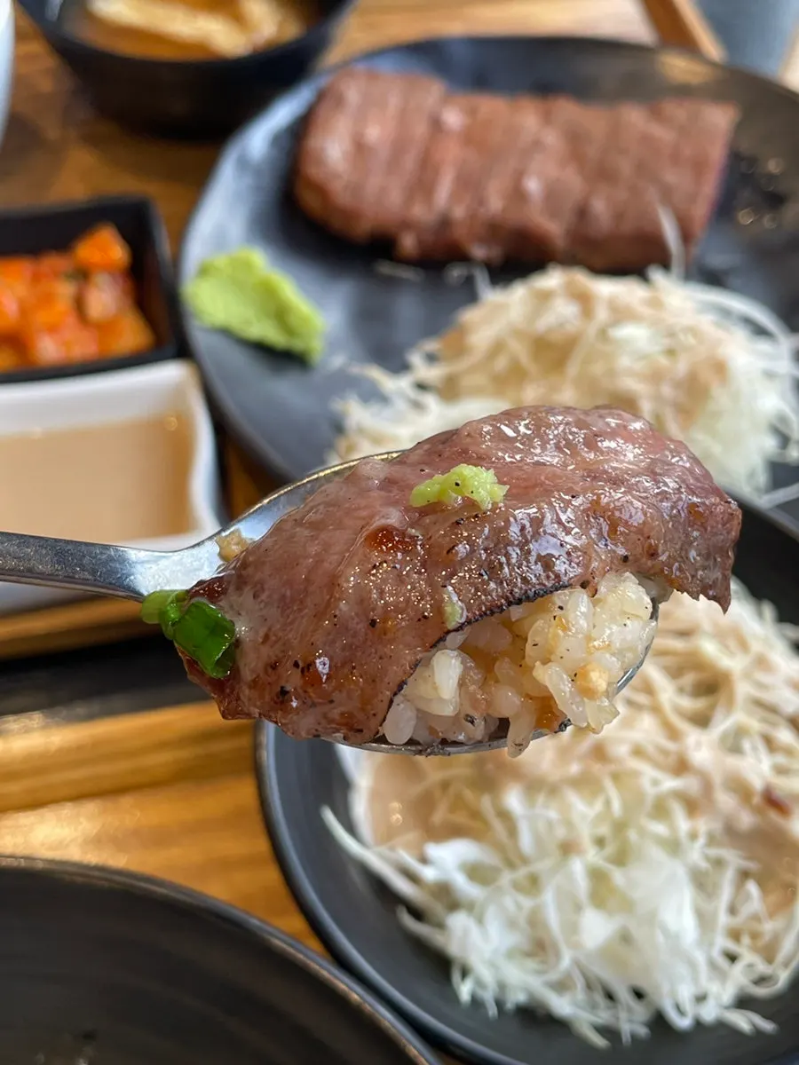 A piece of gyukatsu dipped in sauce