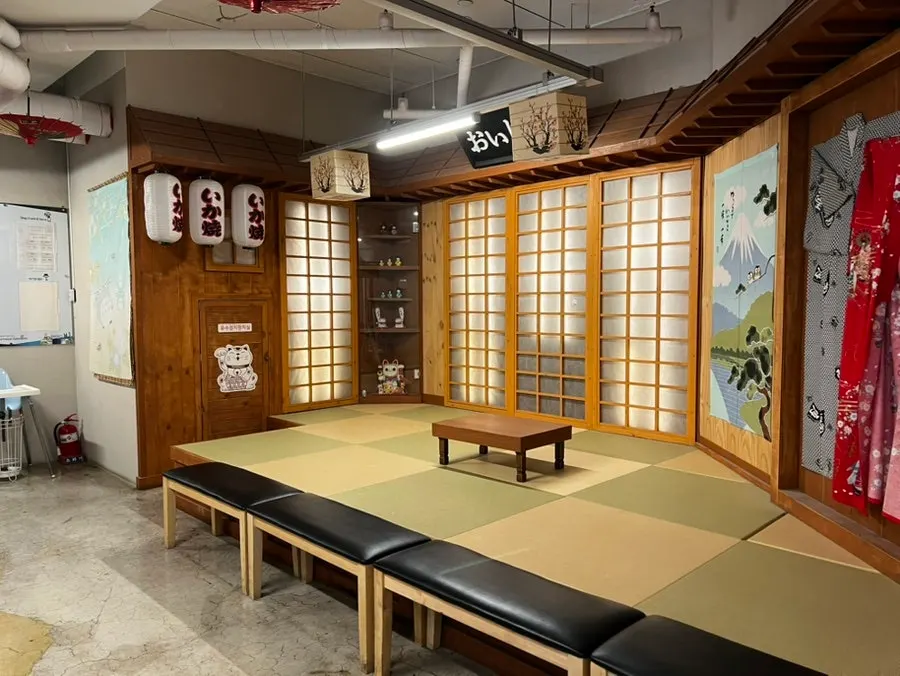 Waiting seats out front of Izawa, styled with a Japanese restaurant atmosphere