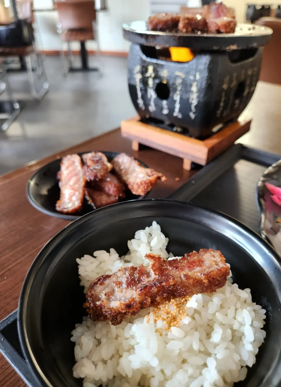A piece of gyukatsu placed on top of rice