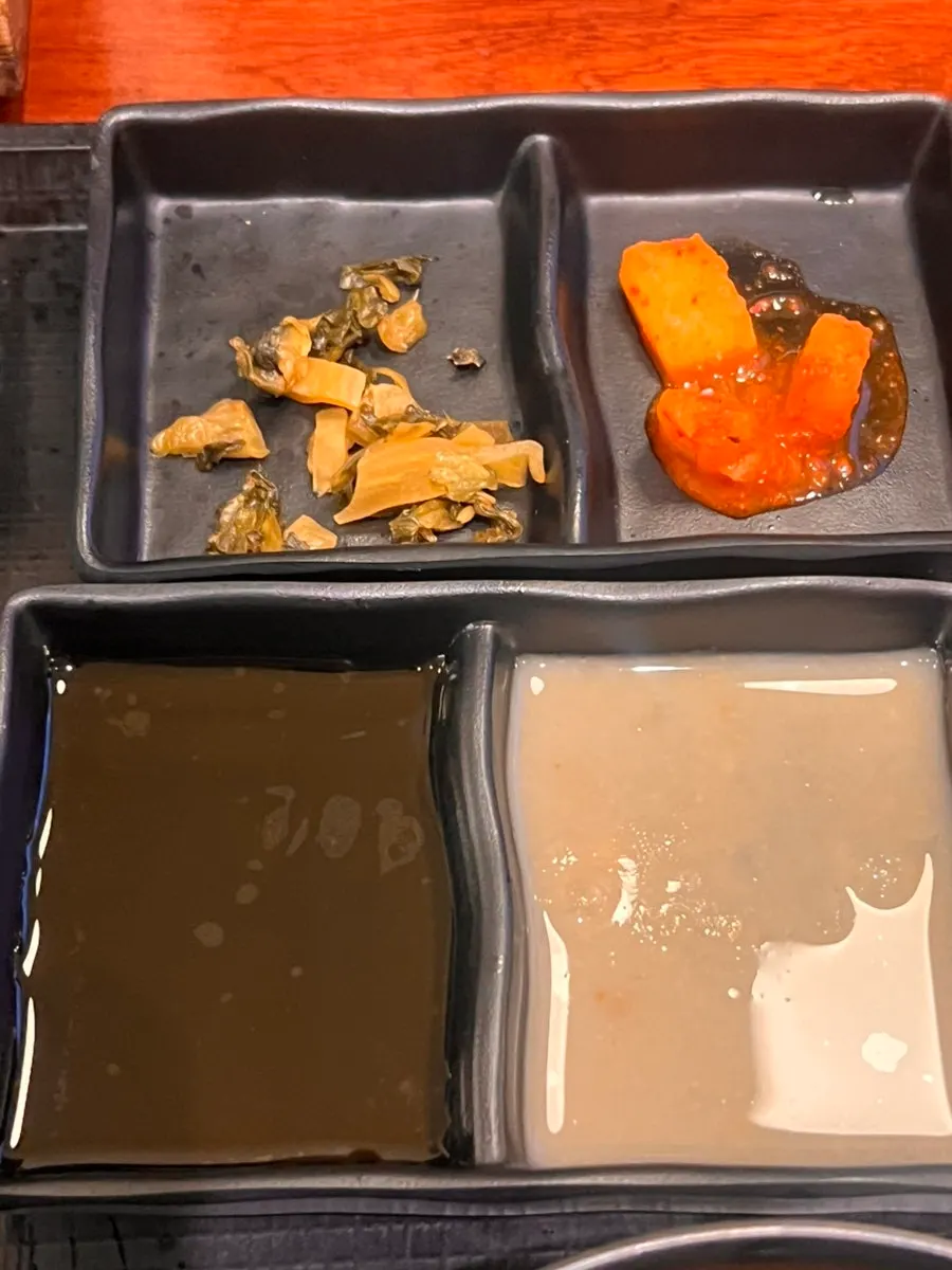 Peanut sauce, teriyaki sauce, and wasabi on a plate
