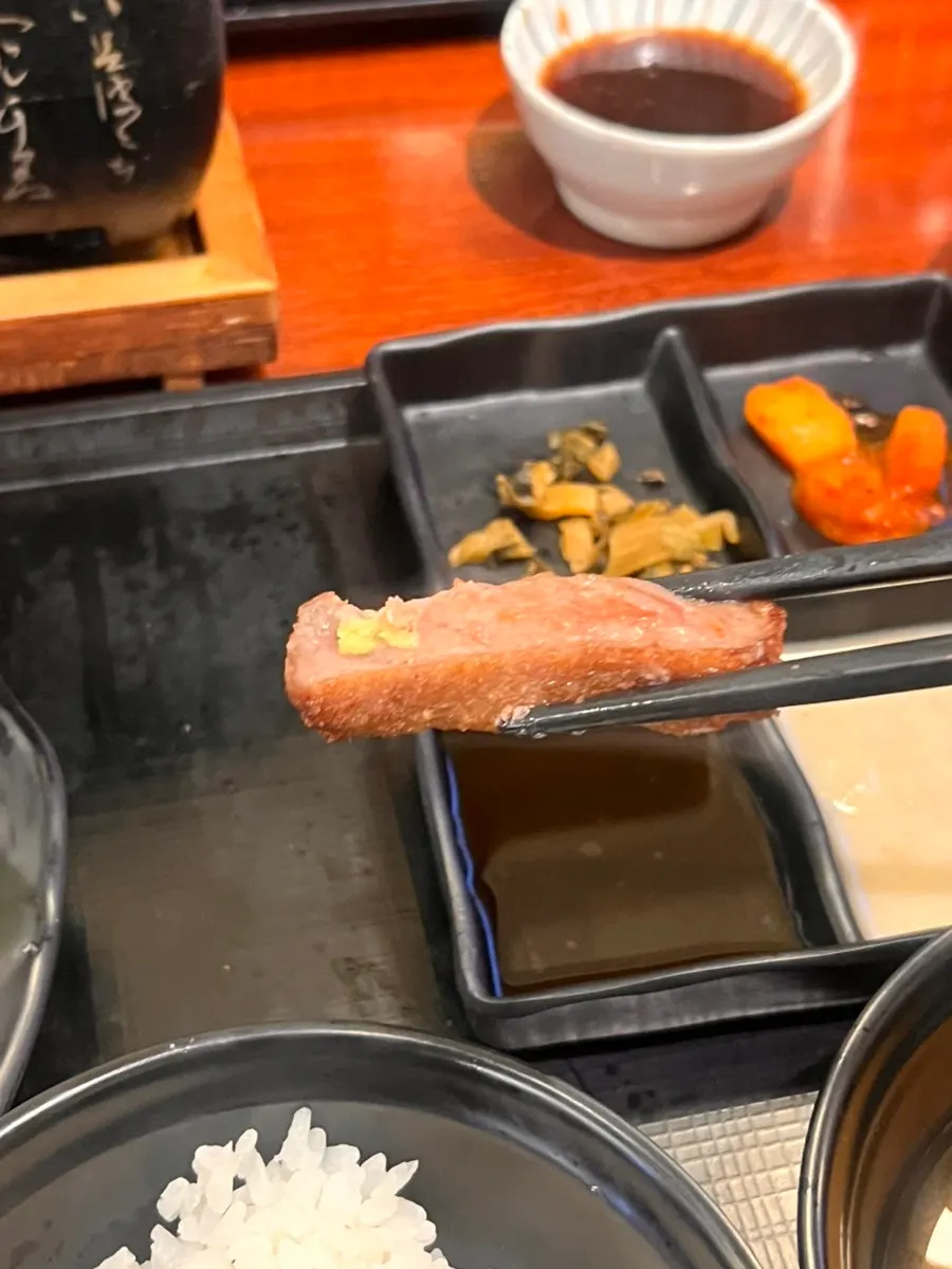 Pink salt and steak sauce set out on the table
