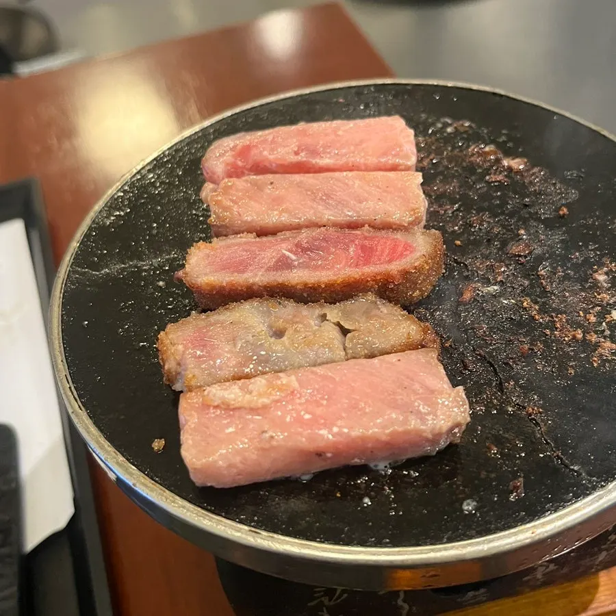 A piece of gyukatsu grilling on the plate