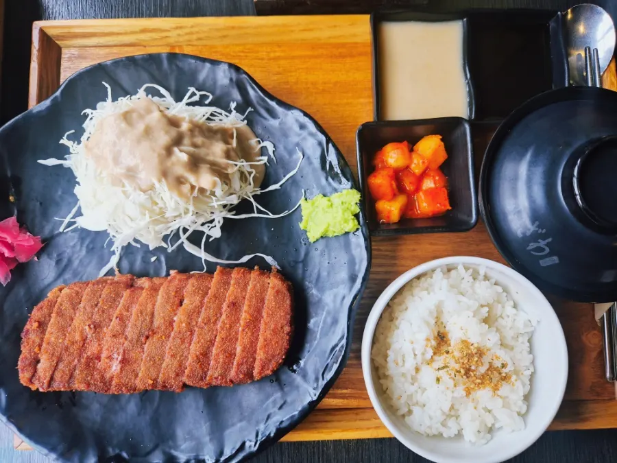 Single-serving spread of gyukatsu, rice, soup, diced radish kimchi and salad