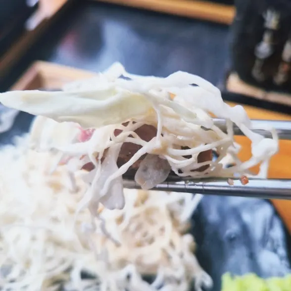 A piece of gyukatsu dipped in sauce