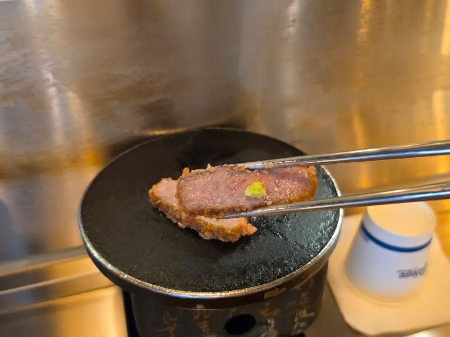Cross-section of medium-rare gyukatsu on the plate