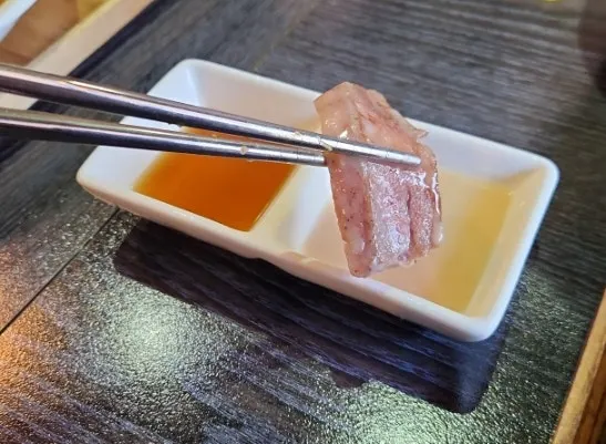 A piece of steak topped with wasabi