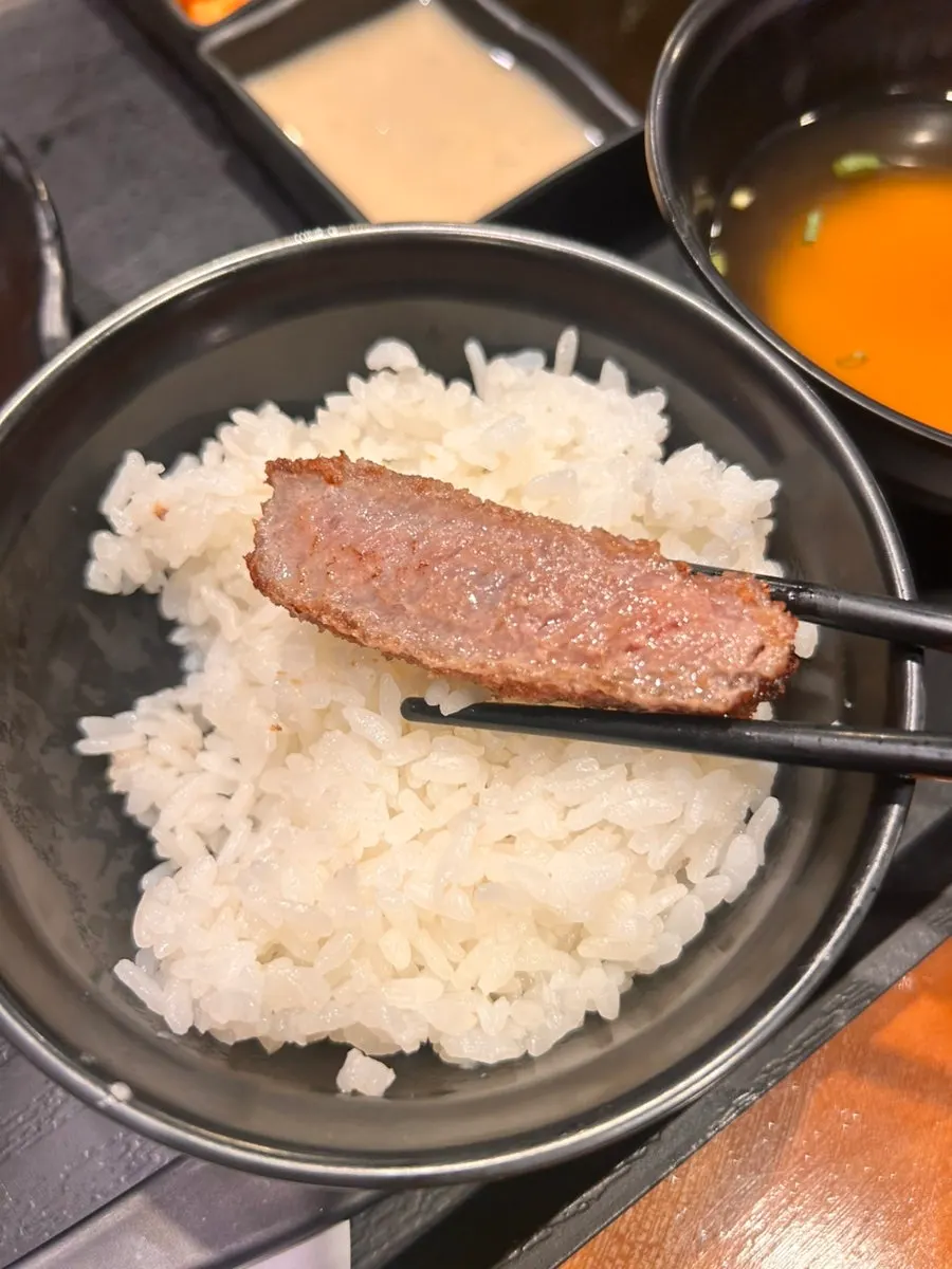 A piece of gyukatsu topped with wasabi
