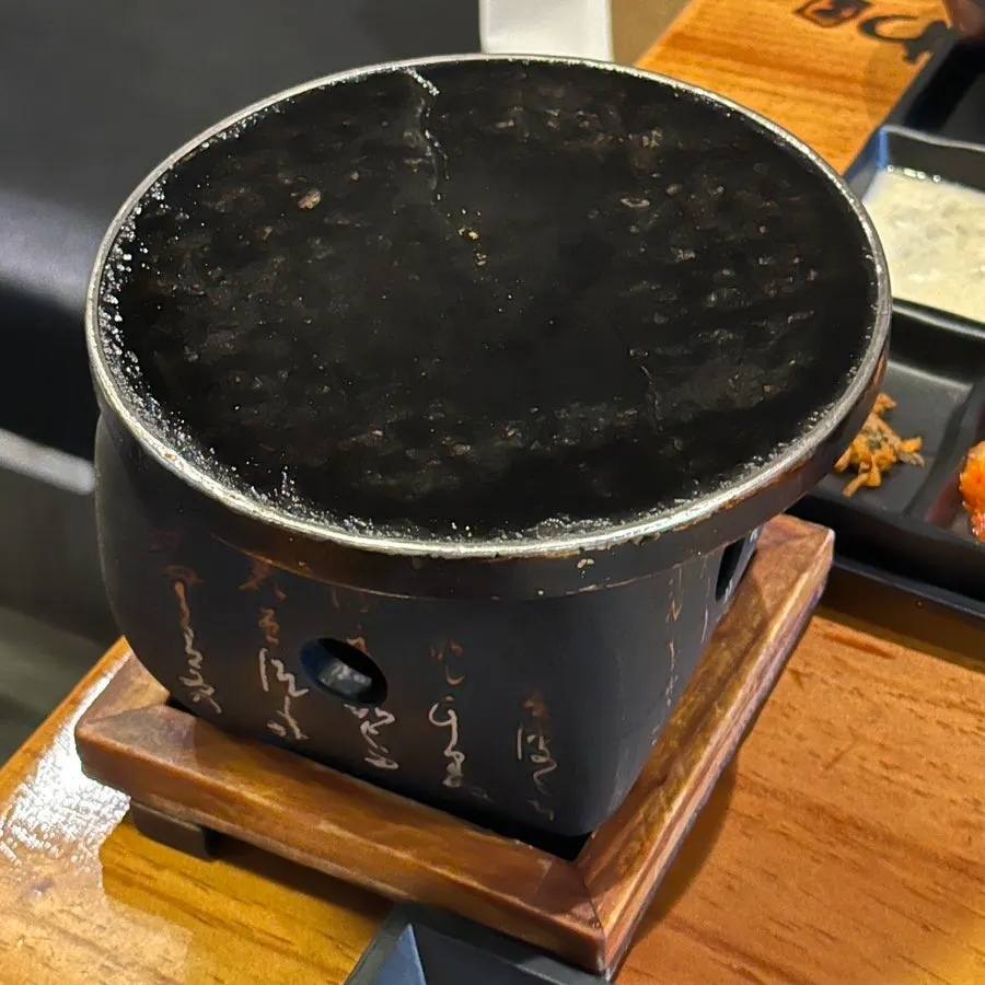 A piece of gyukatsu placed on the mini grill