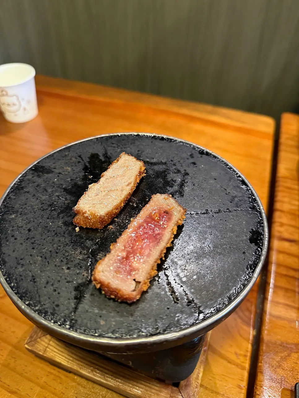 A piece of gyukatsu being grilled on the stove