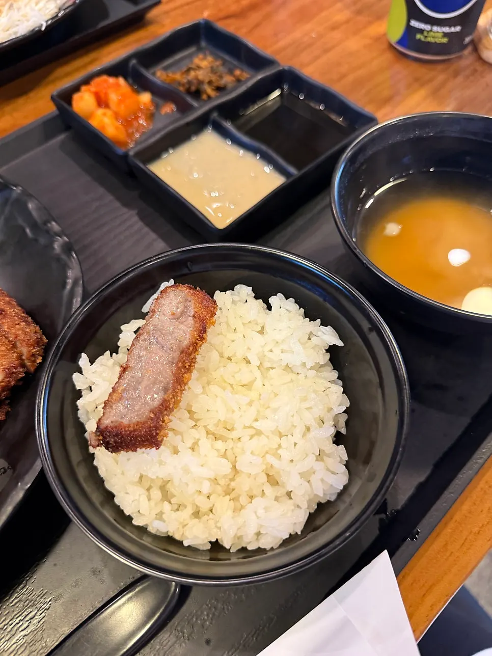 A piece of gyukatsu eaten together with rice