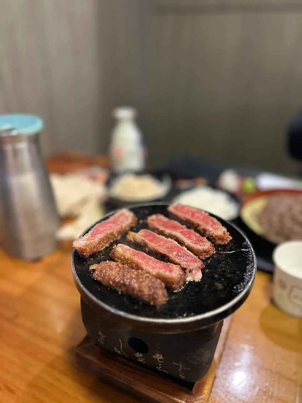 Bright red gyukatsu cooking on the grill
