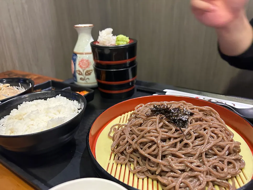 A bite of momil noodles combined with gyukatsu