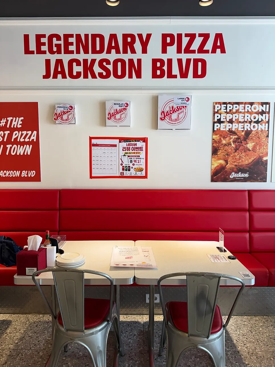 Menu board listing personal and large pizza sizes
