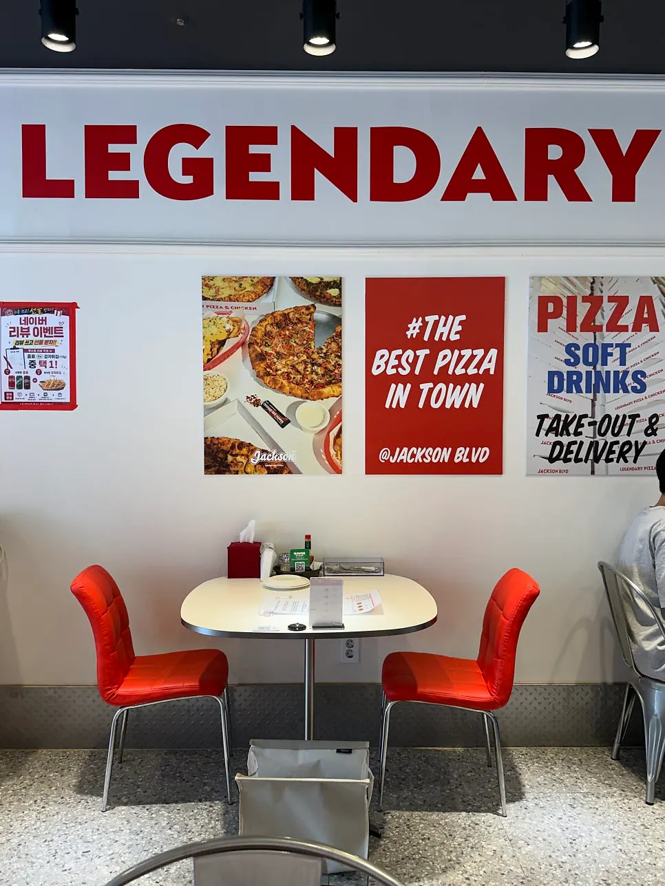 Dining area with sofa seating and tables at Jackson Pizza Wirye Branch