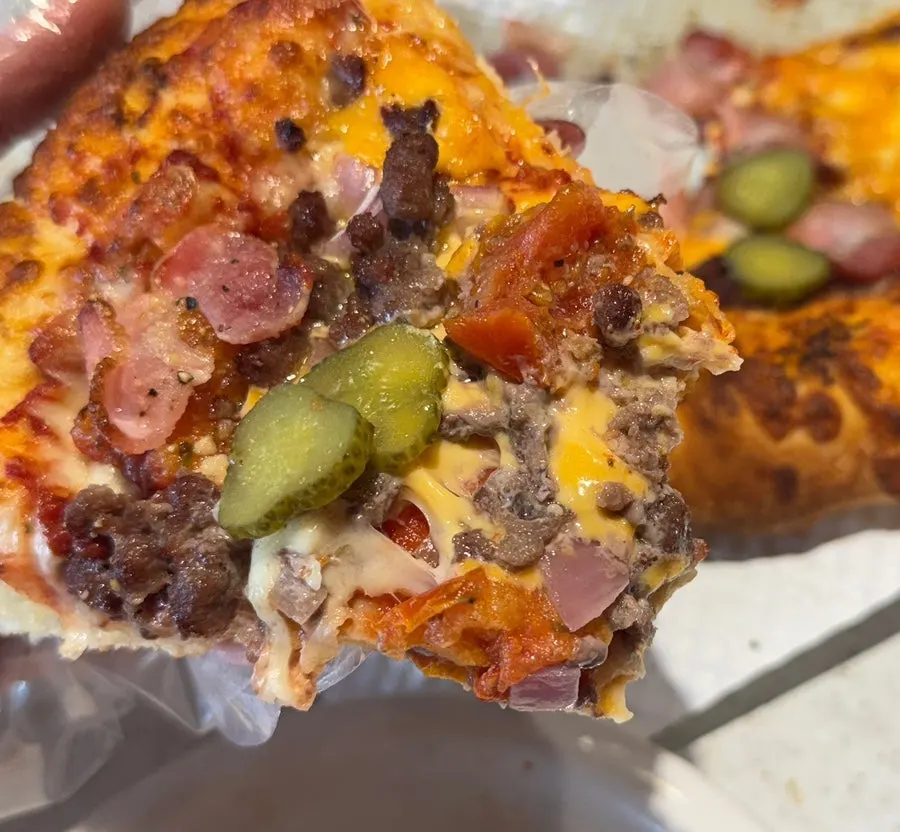 Close-up of a Melting Cheeseburger pizza slice