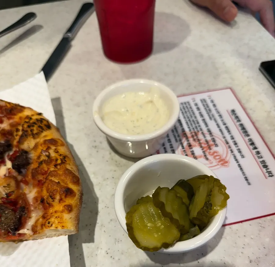 The last slice of pizza with dipping sauce