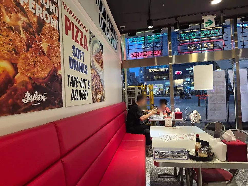 Store interior with JACKSON BLVD sign and neon lights