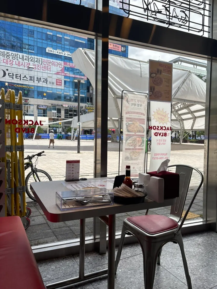 Sunlit window seating at Jackson Pizza Wirye Branch