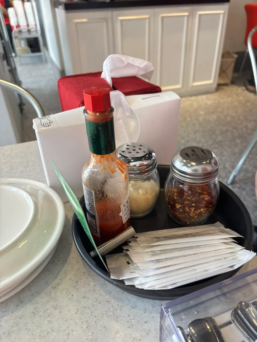 Pizza accessories and sauces at the self-service corner