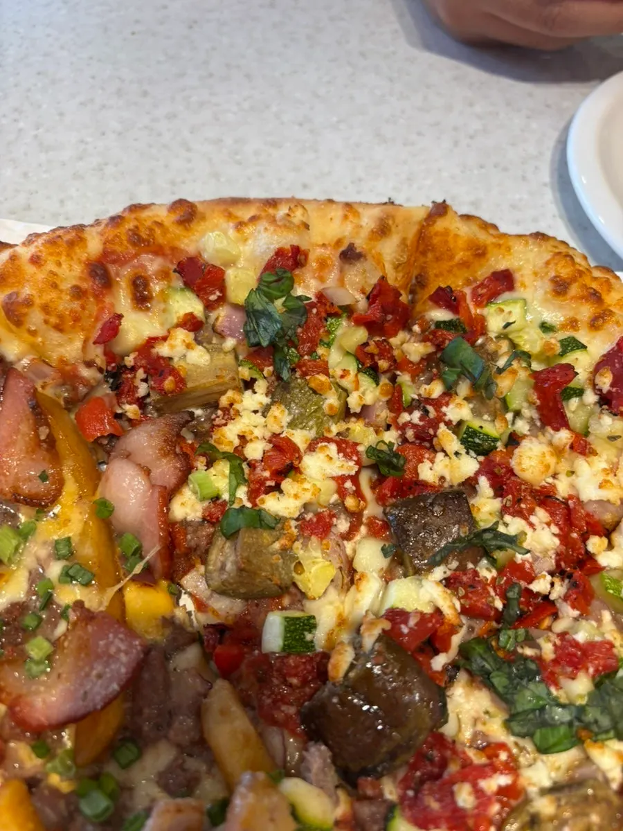 A cheesy slice of Zesty Jackson pizza with stretchy cheese