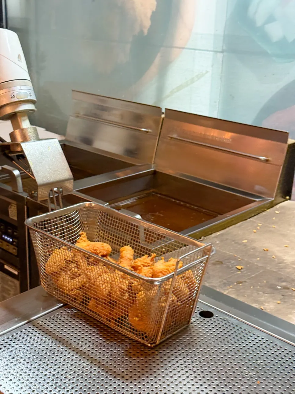 The chicken-cooking robot frying the chicken