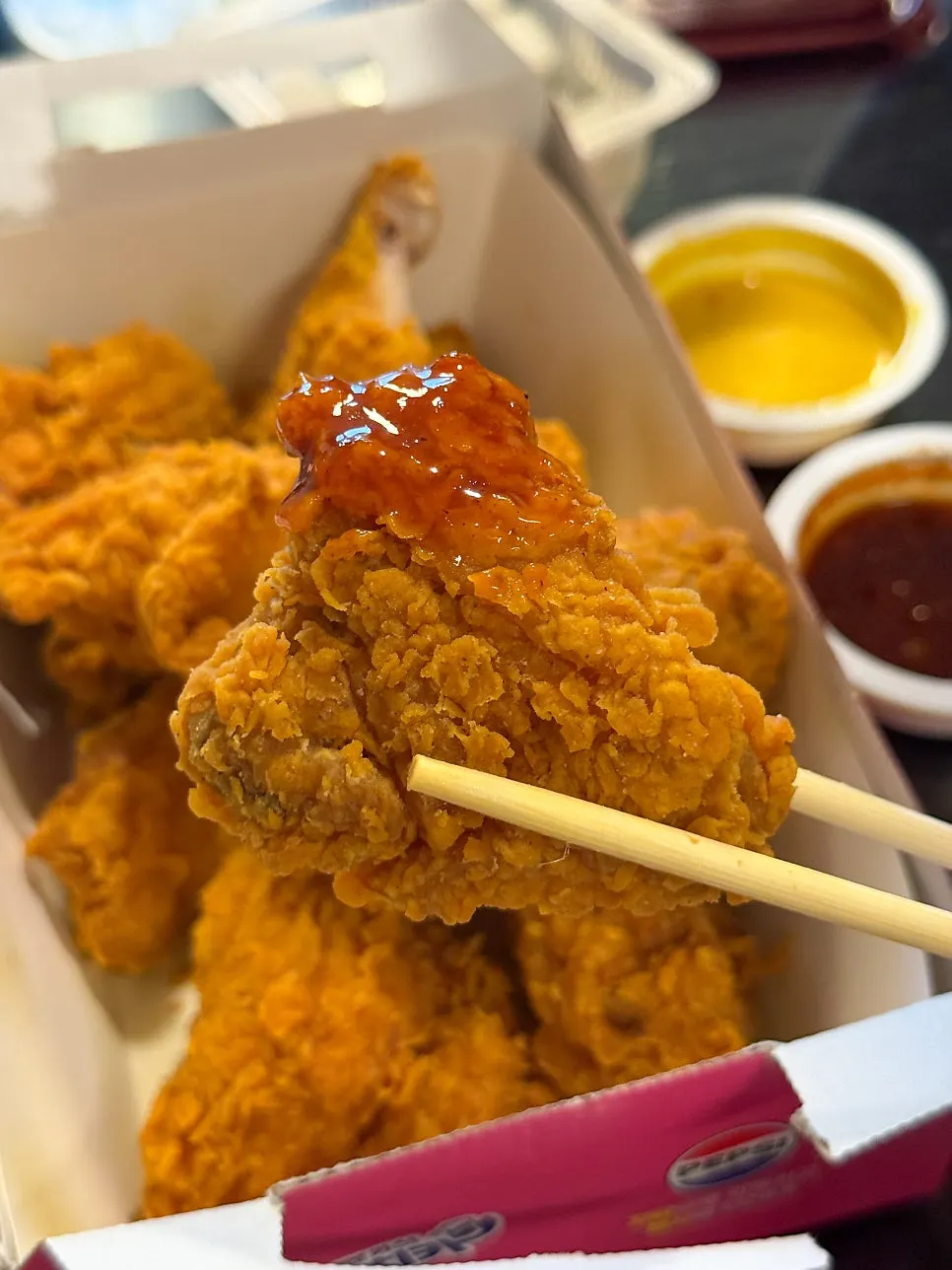 Picking up a piece of the chicken