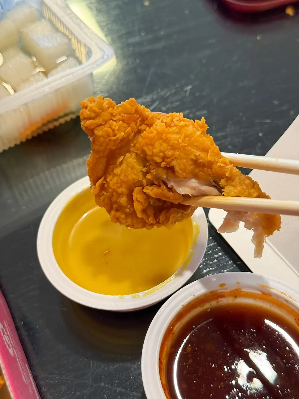 Dipping the fried chicken in sauce