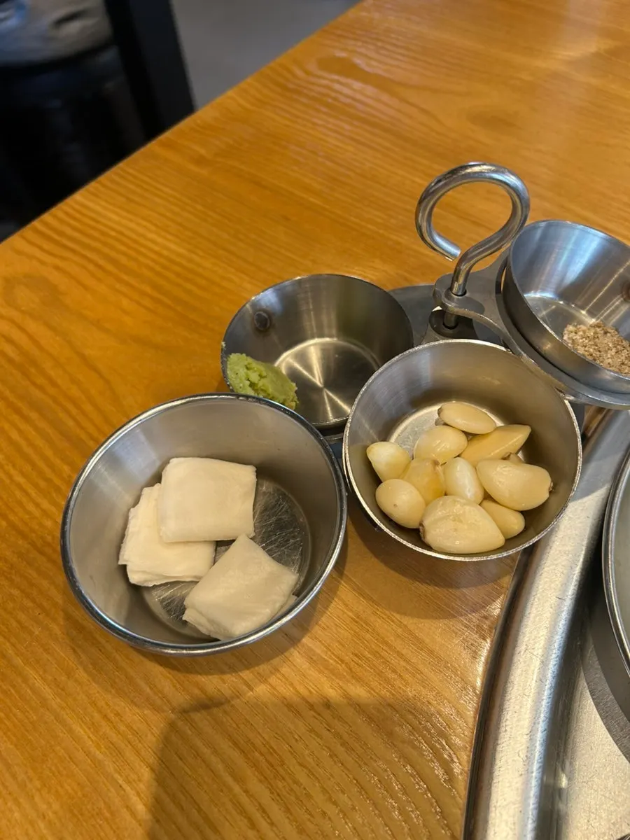 Fat trimmings, wasabi, garlic, and salt set up on the table