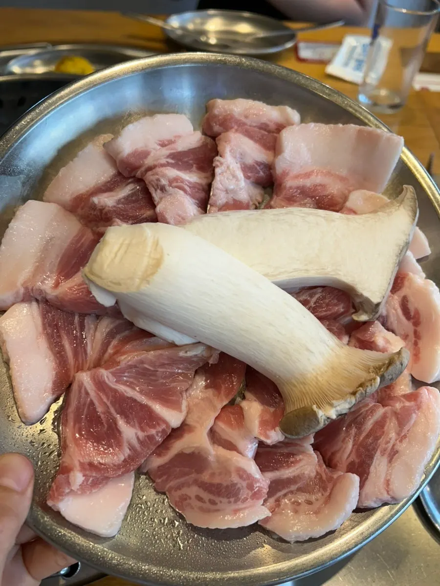 Two servings of kkodeulsal served with king oyster mushrooms