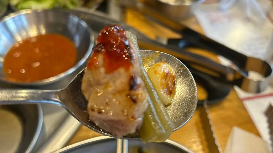 Meat paired with ssamjang, gungchae, and grilled garlic