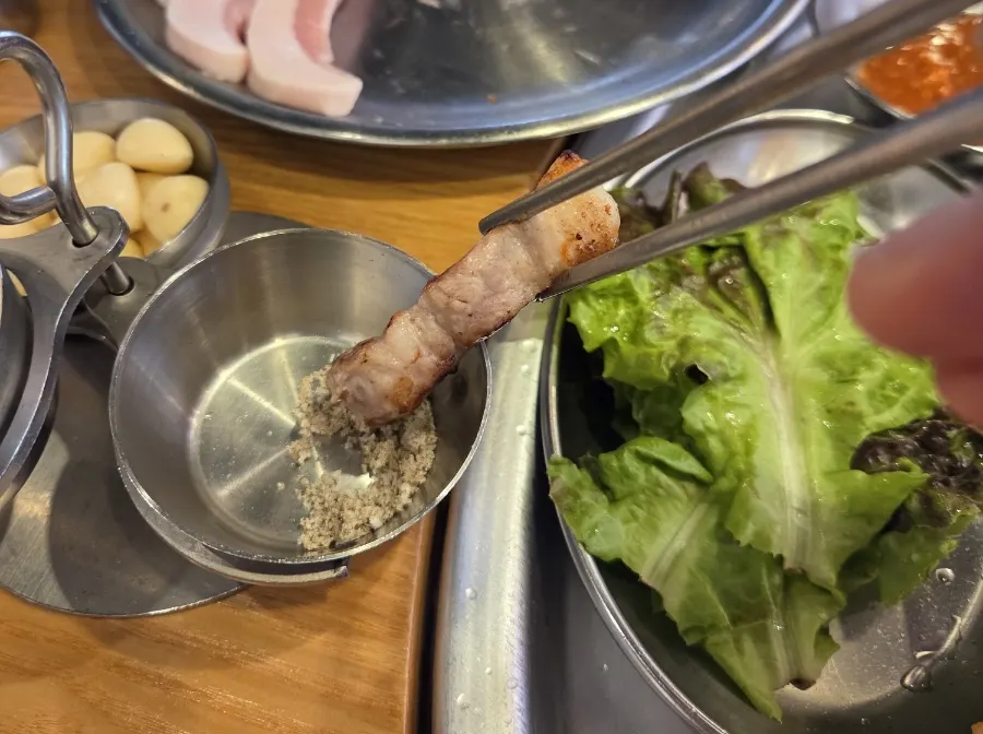 A piece of pork belly dipped in salt