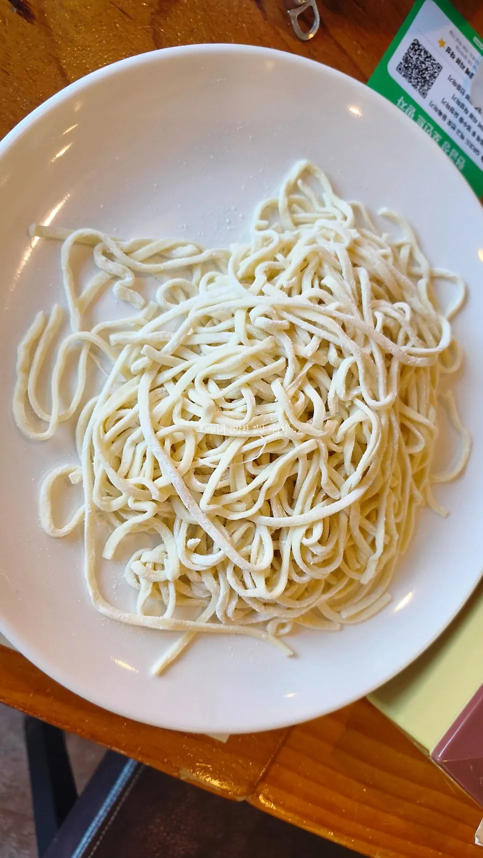 House-made noodles being cooked in the broth