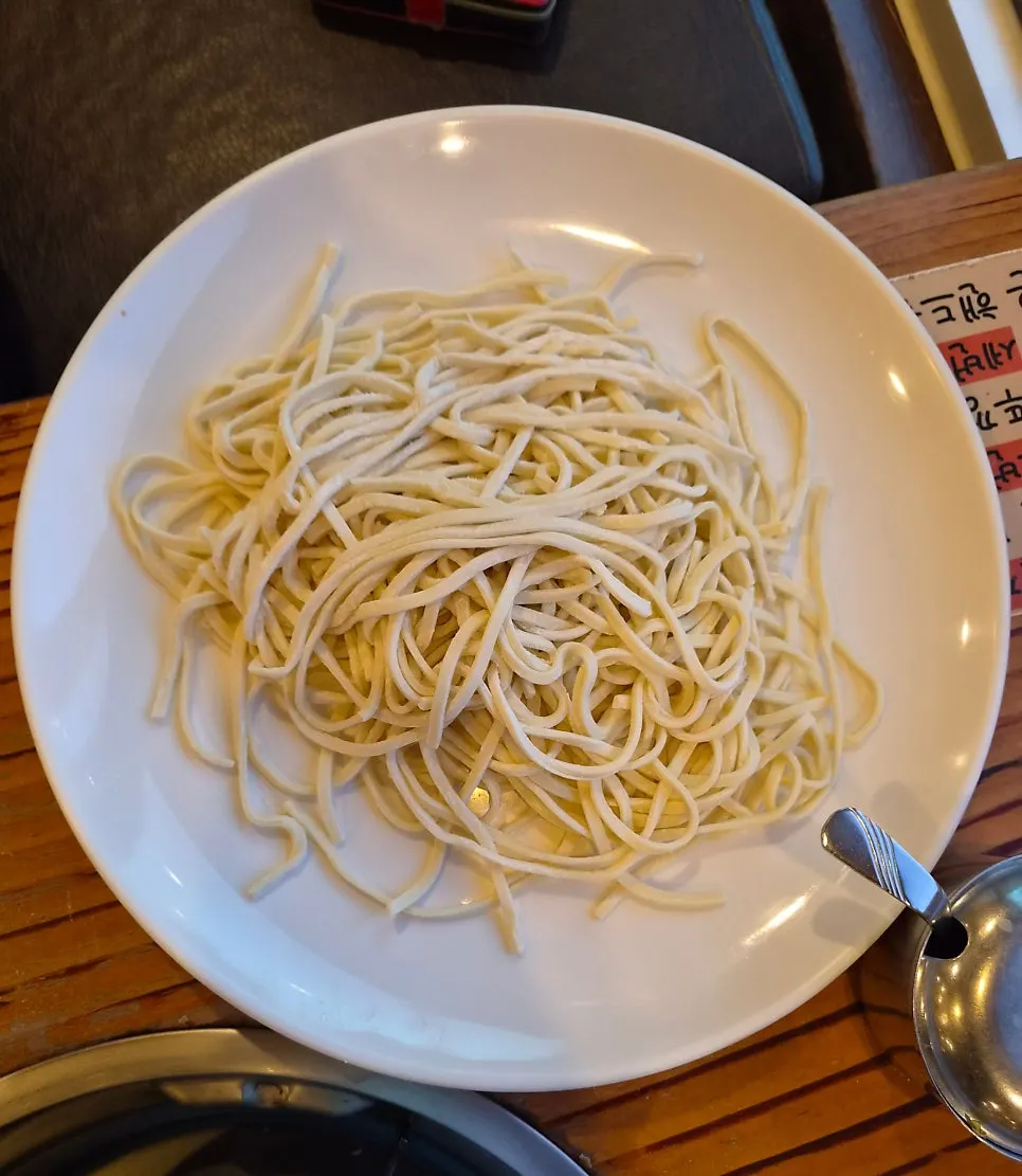 Self-made kalguksu noodles and seafood broth pot