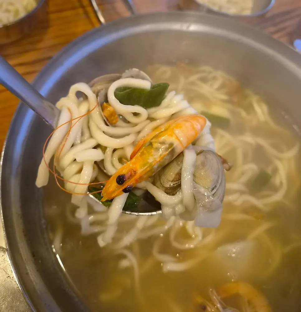A spoonful of the refreshing seafood broth