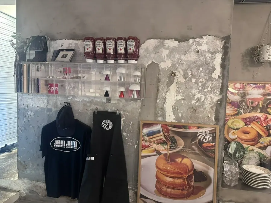 Posters and displayed logo T-shirts and hats inside Jam Jam