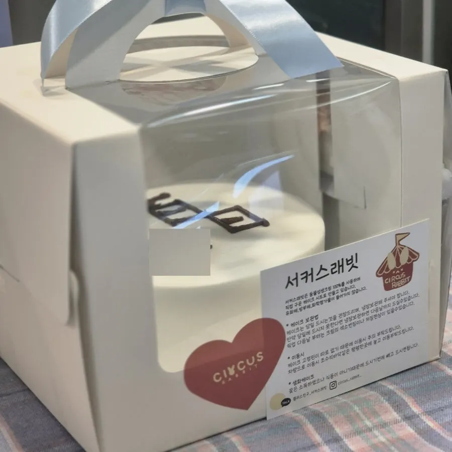 100-day cake packaged and tied with a blue ribbon