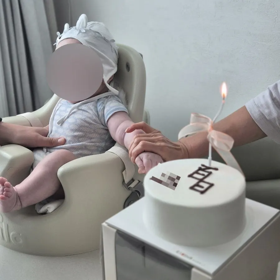100-day cake with ribbon-tied candles inserted