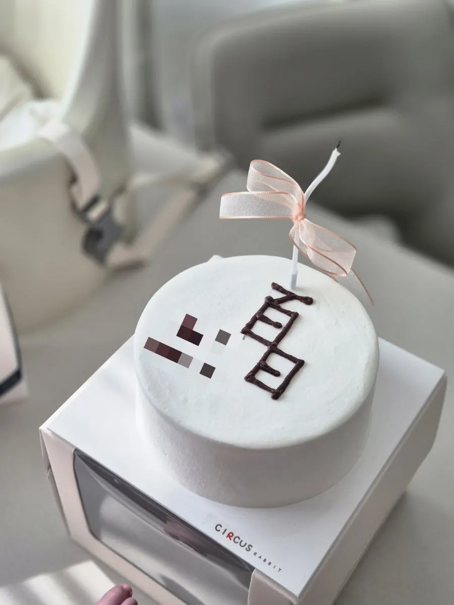 Vertical shot of the white 100-day cake from a distance