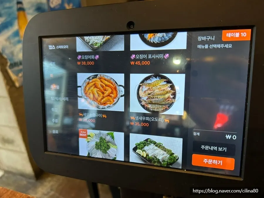 Menu board listing squid sashimi and shrimp dishes
