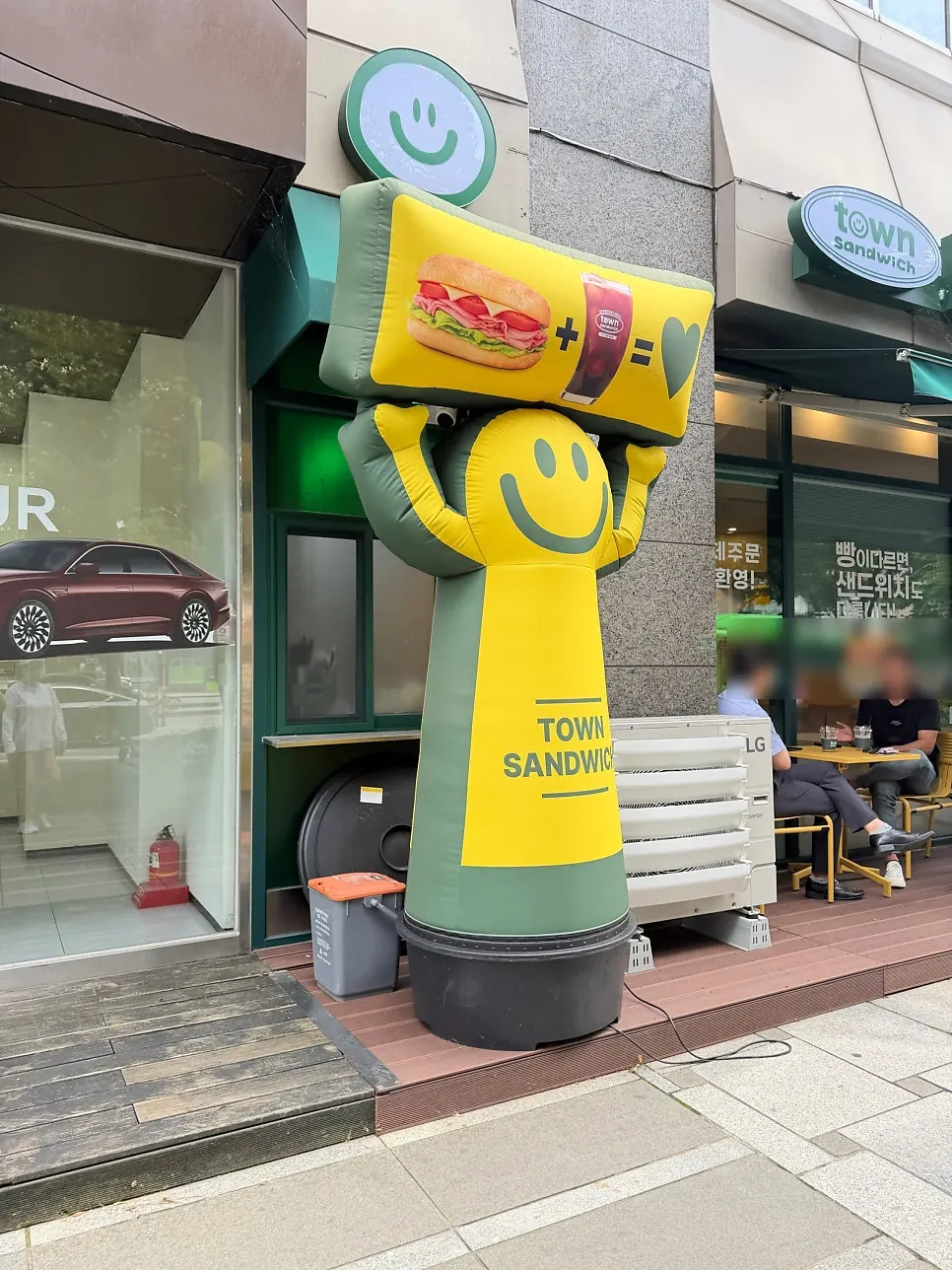 Character with a sandwiches-and-drinks message